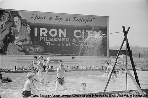 Archival photo of children in a homemade swimming pool