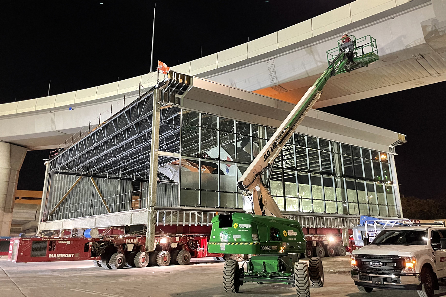 5_Module 5 moving under the Skylink bridge with the help of a team member on the lift.JPG